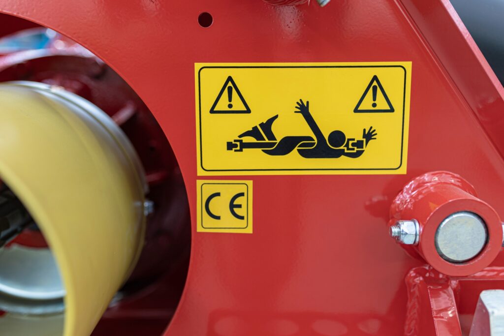 Safety warning sign on industrial equipment in Pennsylvania, relevant to proving liability in a shared fault workplace incident.
