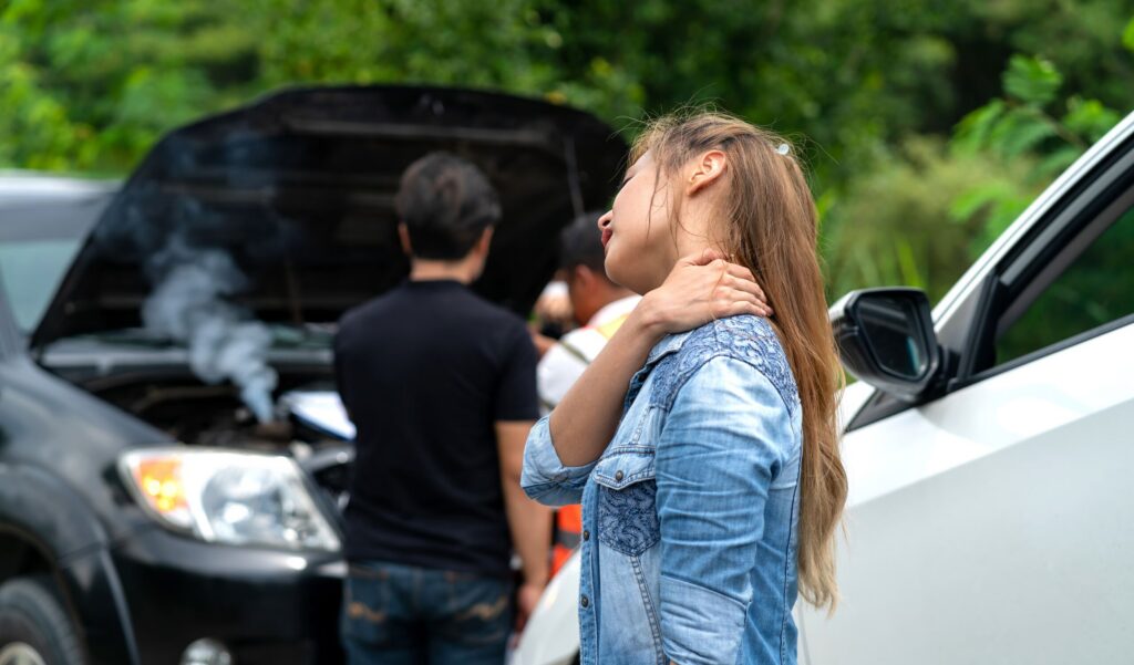 A woman suffering from a neck injury after a Pennsylvania car accident, highlighting the need to prove liability for compensation.