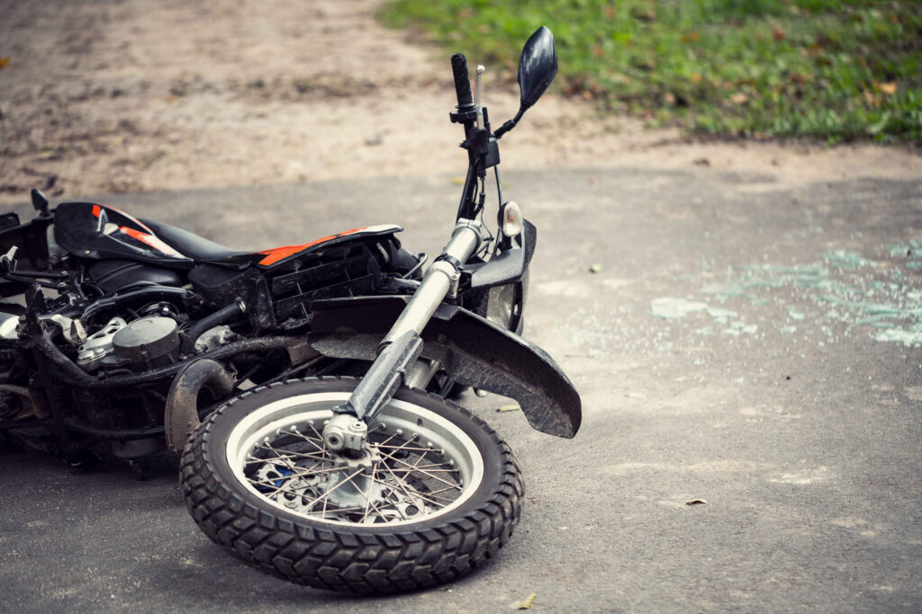 A crashed motorcycle lying on a Pennsylvania roadway after a loss of control due to a dangerous road defect.