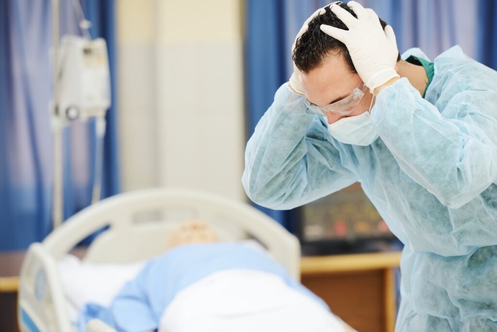 Grieving healthcare worker in a hospital, illustrating the emotional loss addressed in the Pennsylvania wrongful death process.