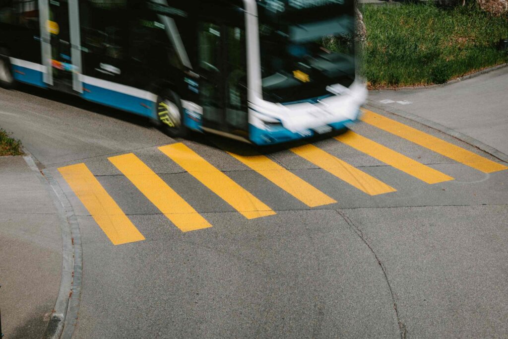 A standard SEPTA bus operating near a transit hub, where pedestrians face increased risks when buses load and unload.
